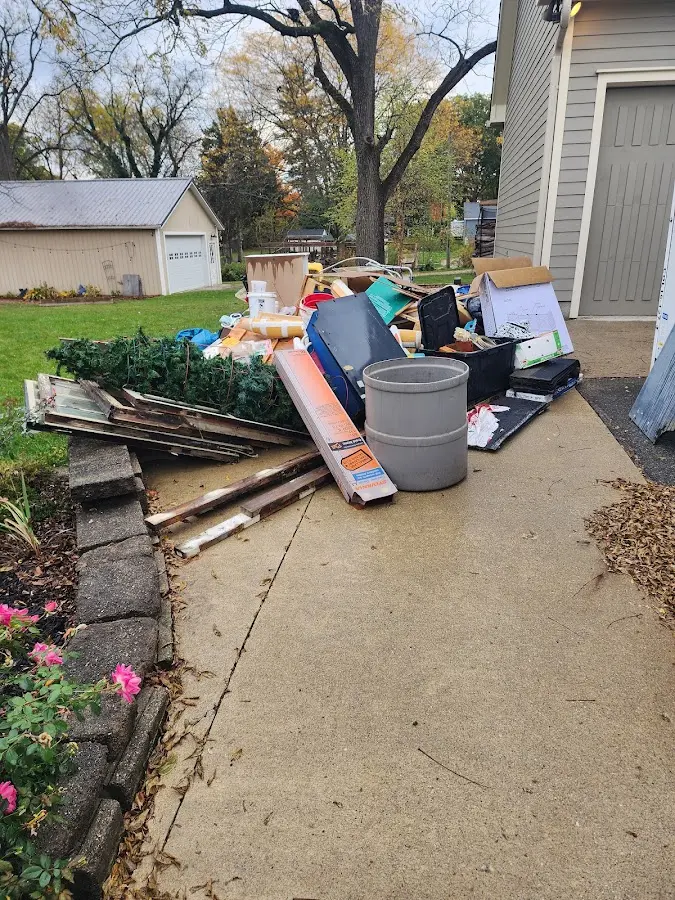 Dumpster being loaded with debris for 3 Yard Dumpster Rental in Howell